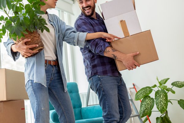 couple-carrying-boxes-while-moving-in-together-2026-01-08-23-49-20-utc