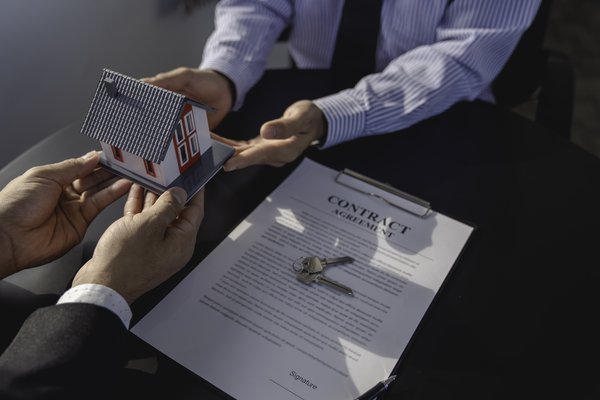 real-estate-agents-handing-over-example-of-a-house-2026-01-08-02-29-04-utc